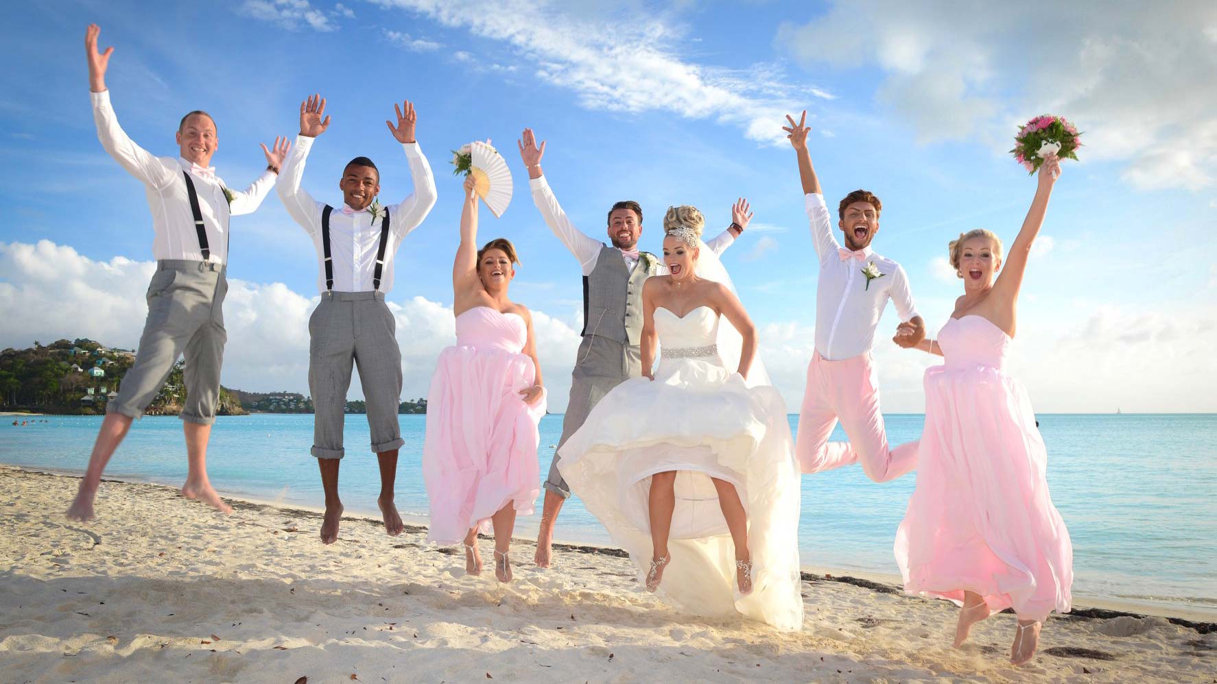 NB Photography wedding party jumping on beach