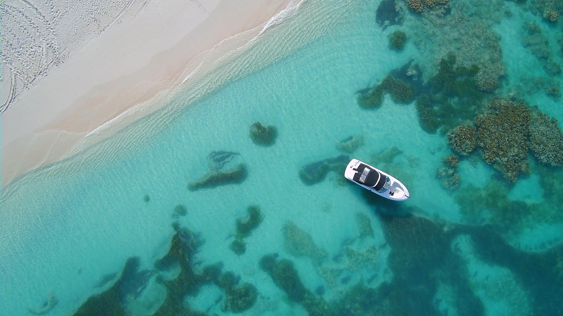 Antigua sand, sea and boat from above